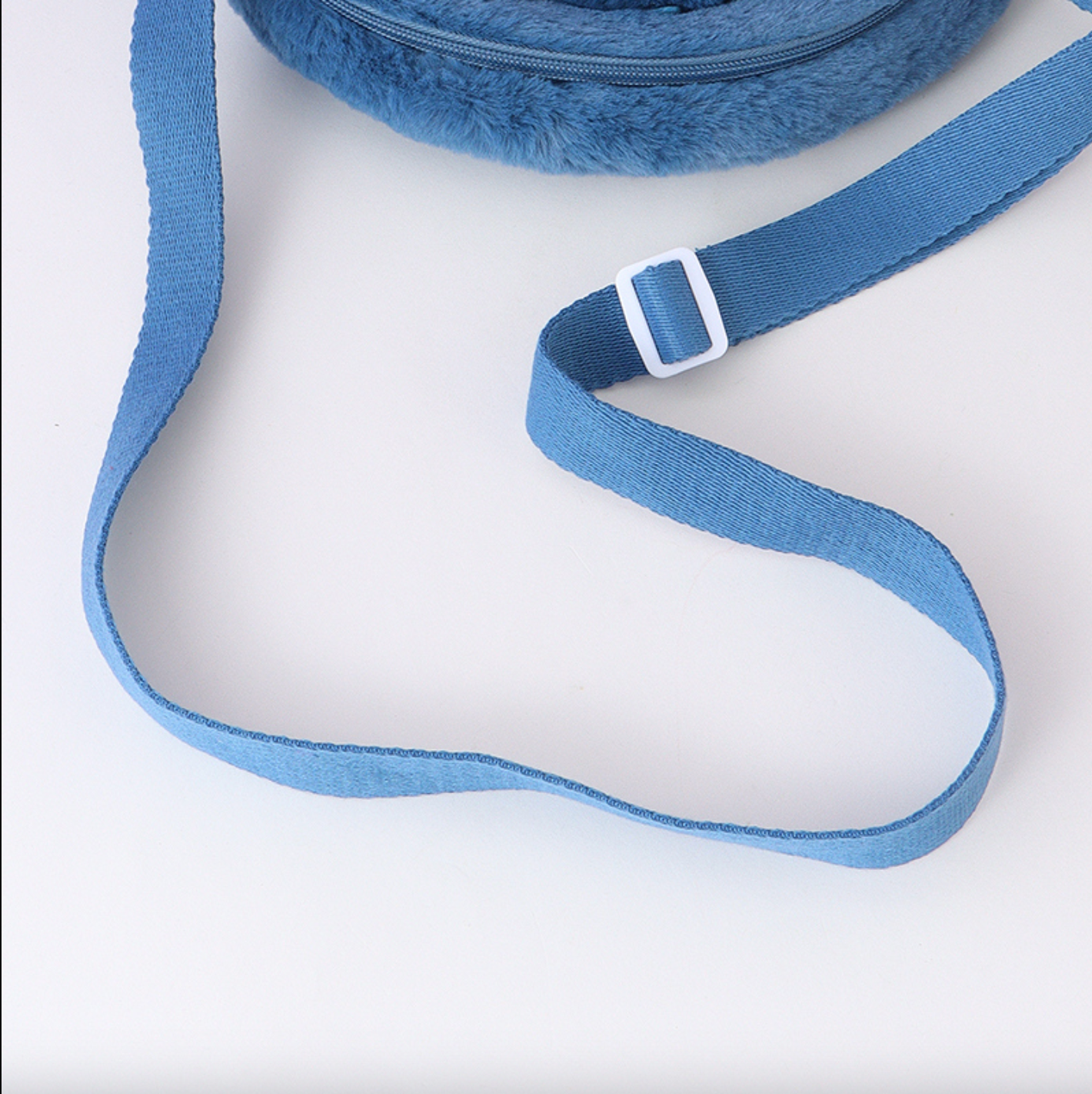 Disney Stitch hangs his ears to show off his baby and crosses his bag diagonally